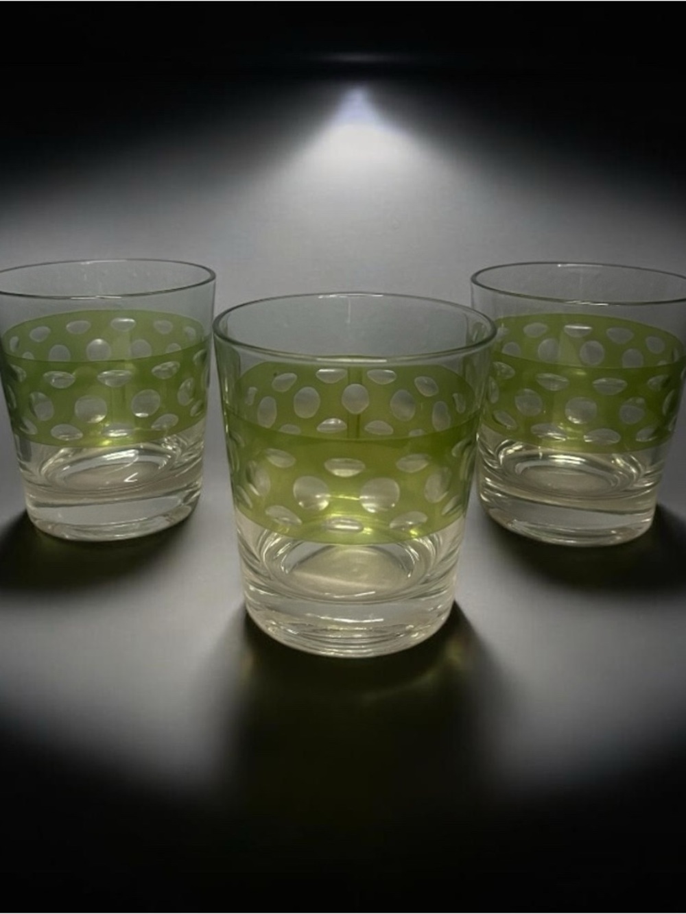 Mid Century lowball/rock glasses featuring green polka dot “coin dot” band
